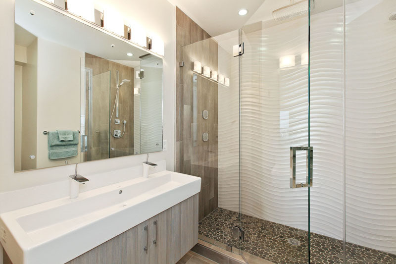 Идеи плитки для ванной комнаты - установите 3D-плитку, чтобы добавить текстуру в вашу ванную комнату // Эти волнистые плитки вместе с галечным полом в душе и деревянными деталями придают этой ванной современный пляжный вид.