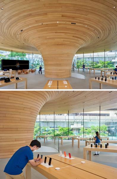 Apple Central World имеет привлекательный цилиндрический стеклянный фасад с видом на большое скульптурное деревянное ядро.