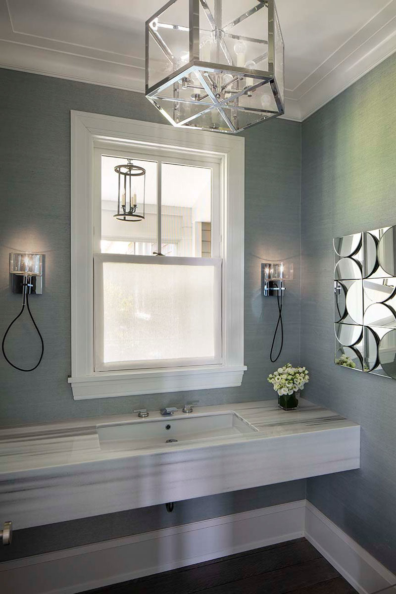 Идеи для ванных комнат - в этой современной ванной комнате стены покрыты текстурированными серыми обоями, а хромированные акценты были добавлены в виде освещения и настенного искусства. #BathroomIdeas #BathroomDesign #GreyBathroom