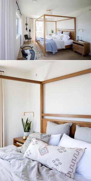 В этой главной спальне обращает на себя внимание современная деревянная кровать с балдахином. Другая мебель включает деревянные прикроватные тумбочки, черный стул, настенные прикроватные лампы, подвесное растение в углу и коврик.