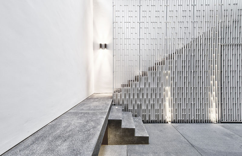 Металлические перила на этих лестницах имеют вертикальный узор и добавляют пространству пространства.