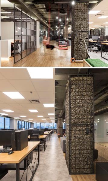 Колонны, будь то на рабочем месте или дома, часто оставляют в виде необработанного бетона или просто окрашивают, однако в этом офисе колонны были превращены в акценты, называемые габионами. # Габион # Дизайн рабочего места # Колонны