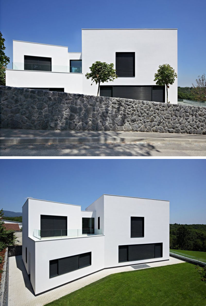  12 Минималистский современный экстерьер дома // Белый экстерьер этого минималистского дома прерывается, но черные оконные покрытия представляют резкий контраст и придают дому современный вид 