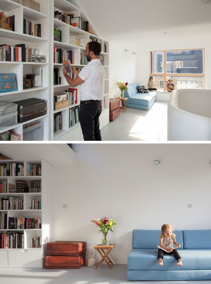 Книжный шкаф, который следует линии потолка, использует белую стену, в то время как диван помогает создать гостиную на открытом пространстве. # Книжная полка # Дизайн интерьера # Гостиная