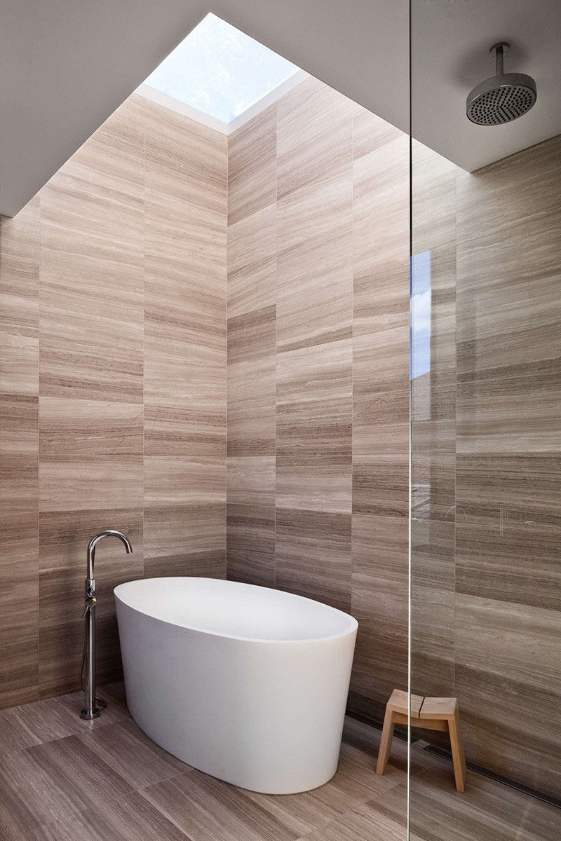 Идея плитки для ванной - используйте одну и ту же плитку на полу и стенах | Плитка на стенах и полах этой ванной комнаты имеет почти древесный вид, что придает пространству теплую атмосферу.