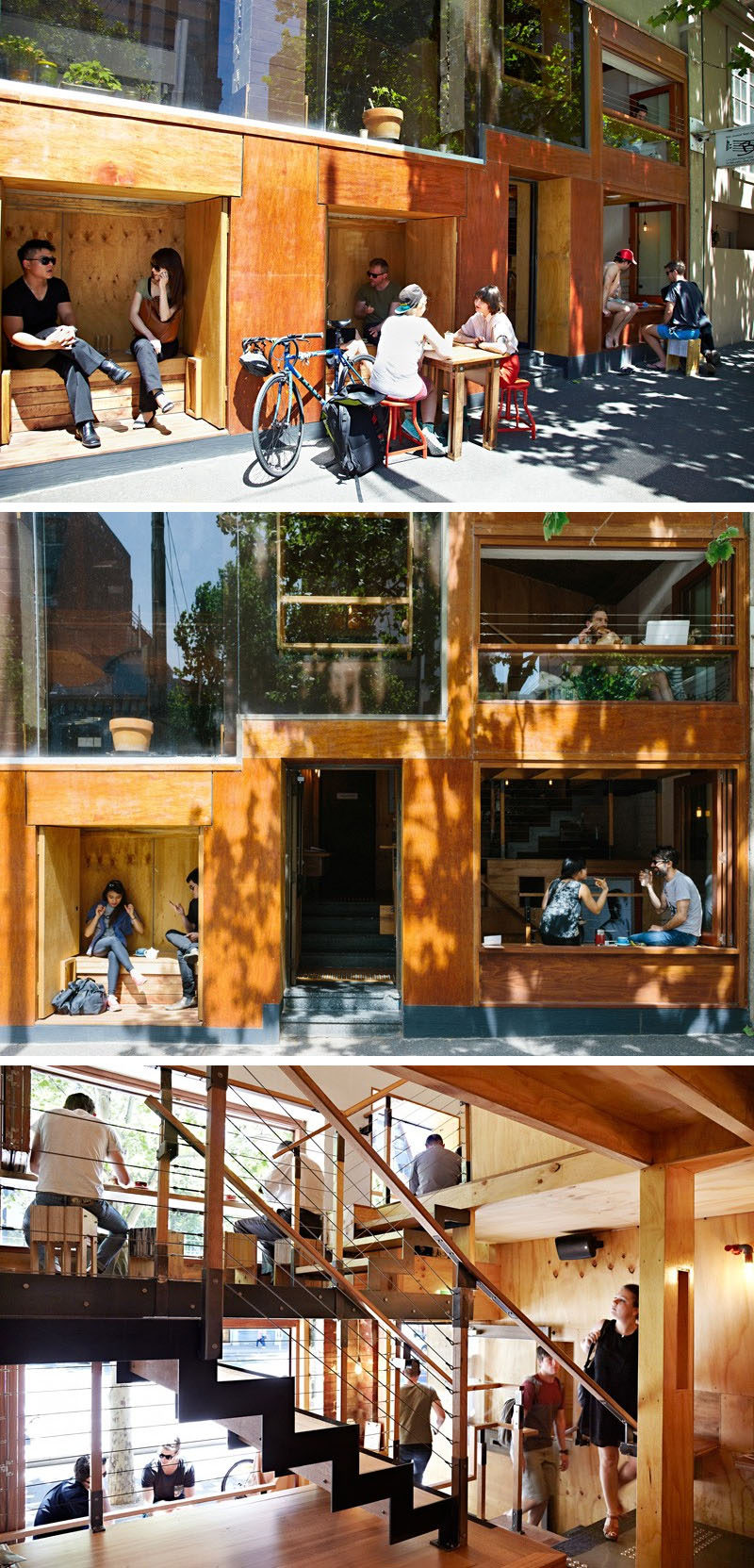 Это современное кафе имеет встроенные деревянные уголки для сидения снаружи кафе, а внутри люди сидят в барах, глядя на улицу.