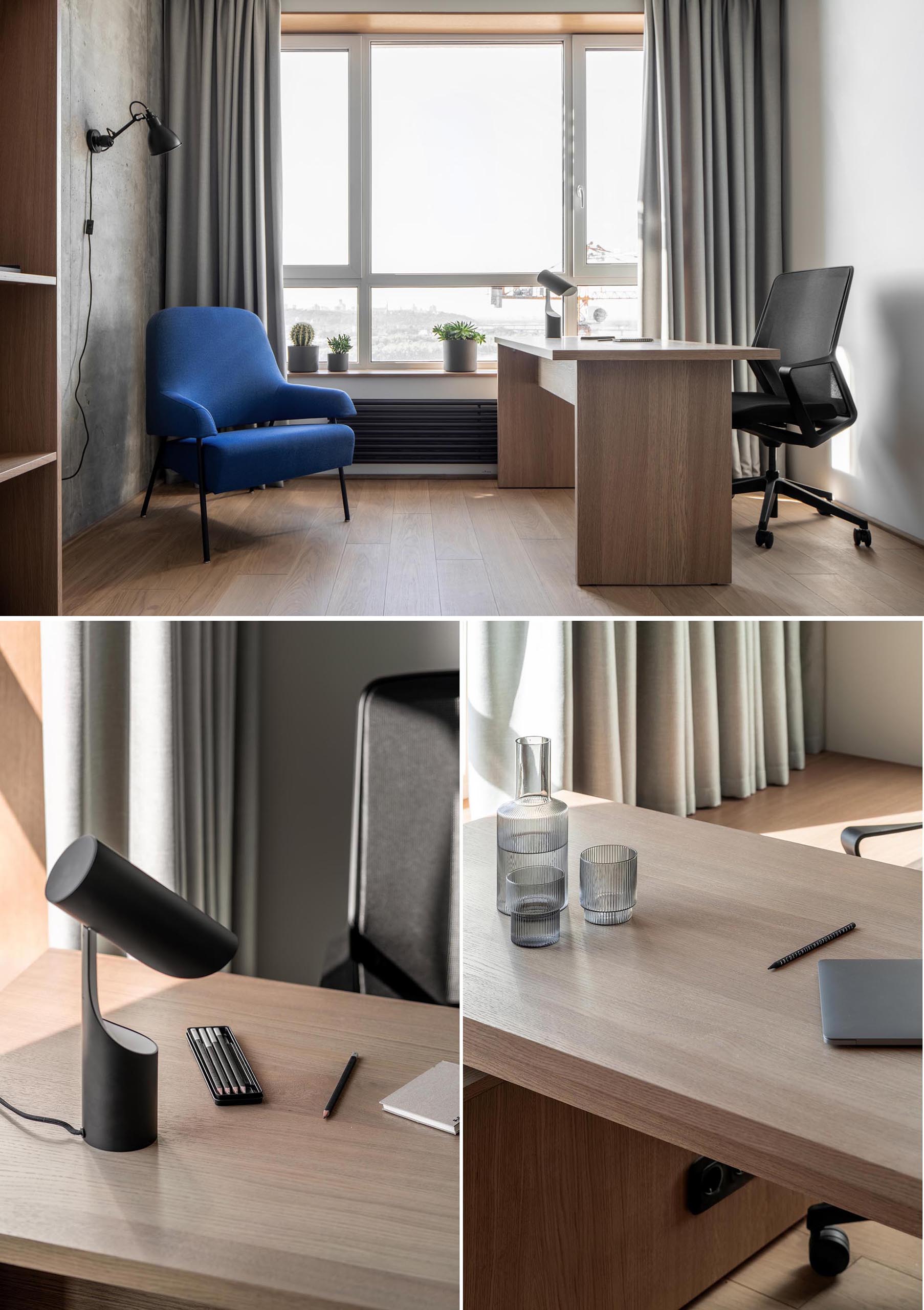 Современный домашний офис с длинными шторами, деревянным столом, синим креслом и бетонной стеной.