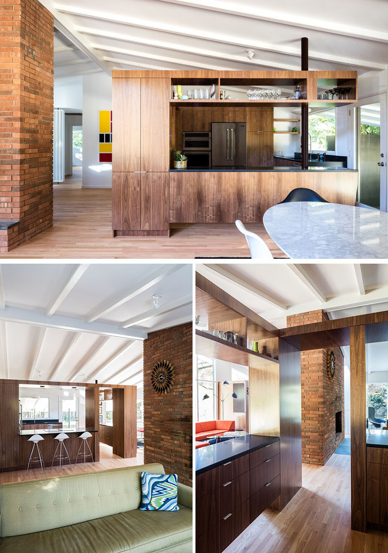 Деревянные шкафы определяют кухню и создают много места для хранения вещей в этом отремонтированном доме.