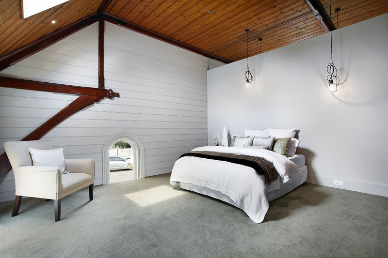 Эта спальня в стиле минимализма демонстрирует форму первоначальной церкви, ее деревянные потолки и архитектурные детали. #BedroomDesign #ChurchConversion 