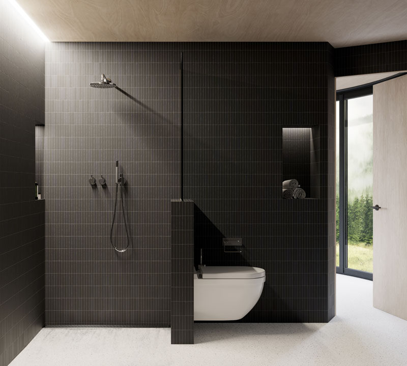  Эта современная ванная комната отделана темной плиткой, которая контрастирует с деревянным потолком, а скрытое освещение помогает сохранить яркость небольшого пространства. # Современная ванная # Дизайн ванной 