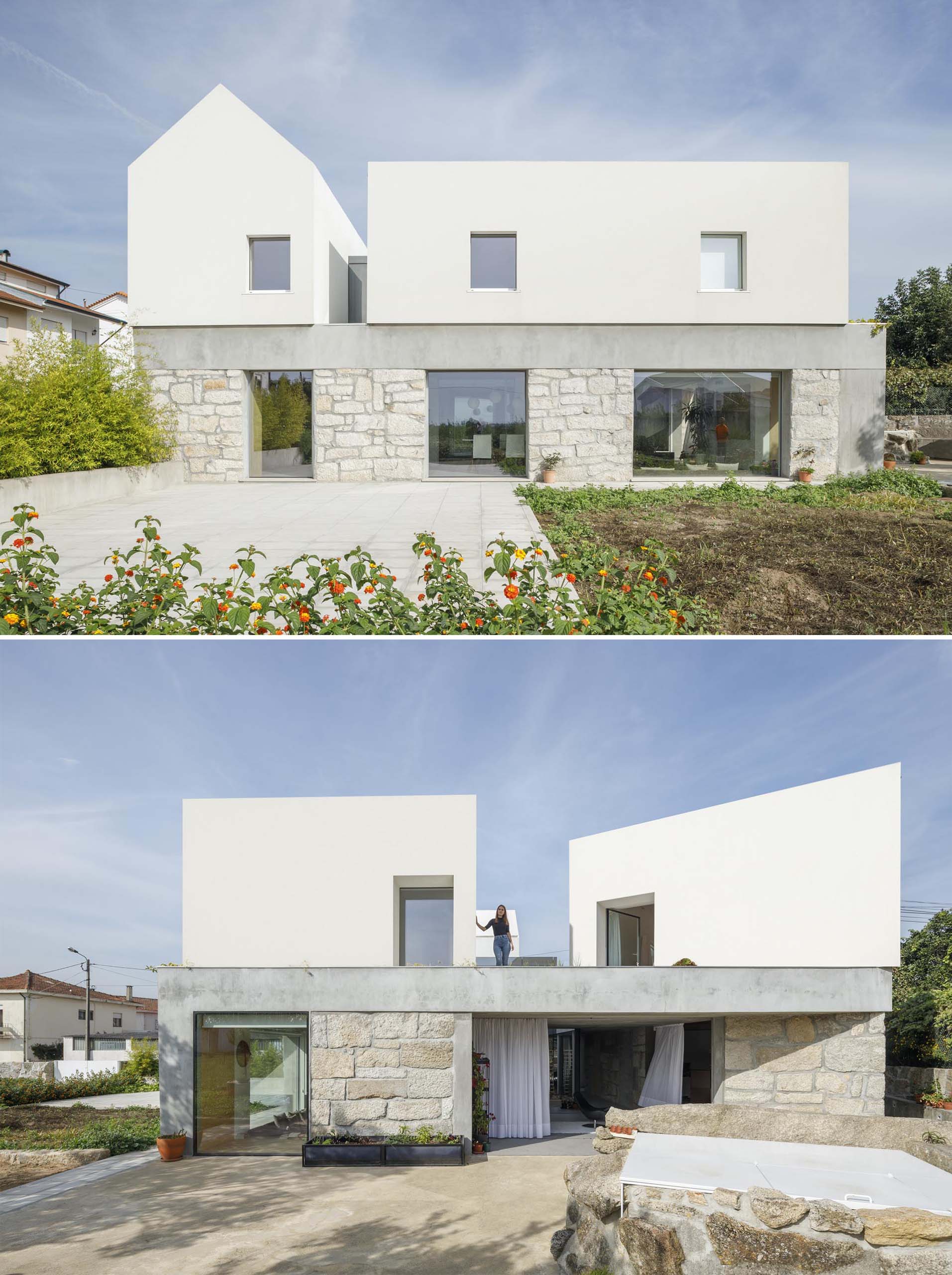Современный дом с каменными стенами и белым верхним этажом.