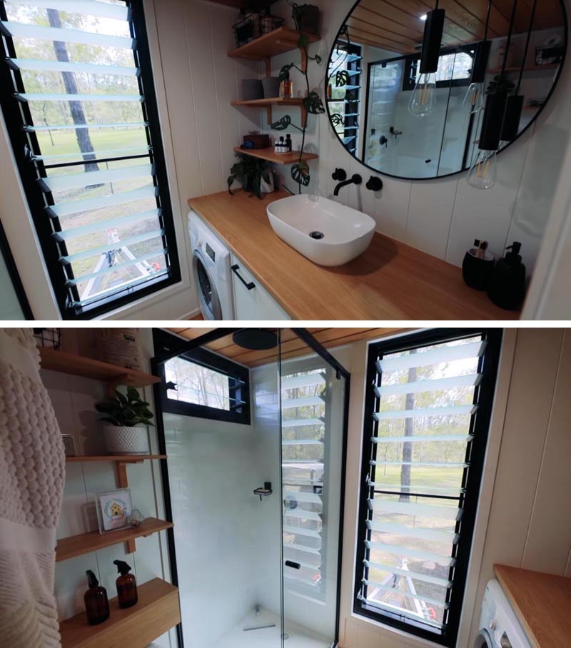 В этой современной ванной крошечного дома есть большой туалетный столик с круглым зеркалом. Также есть полноразмерная душевая кабина, туалет и стиральная машина. #TinyHouseВанная # МаленькаяВанная