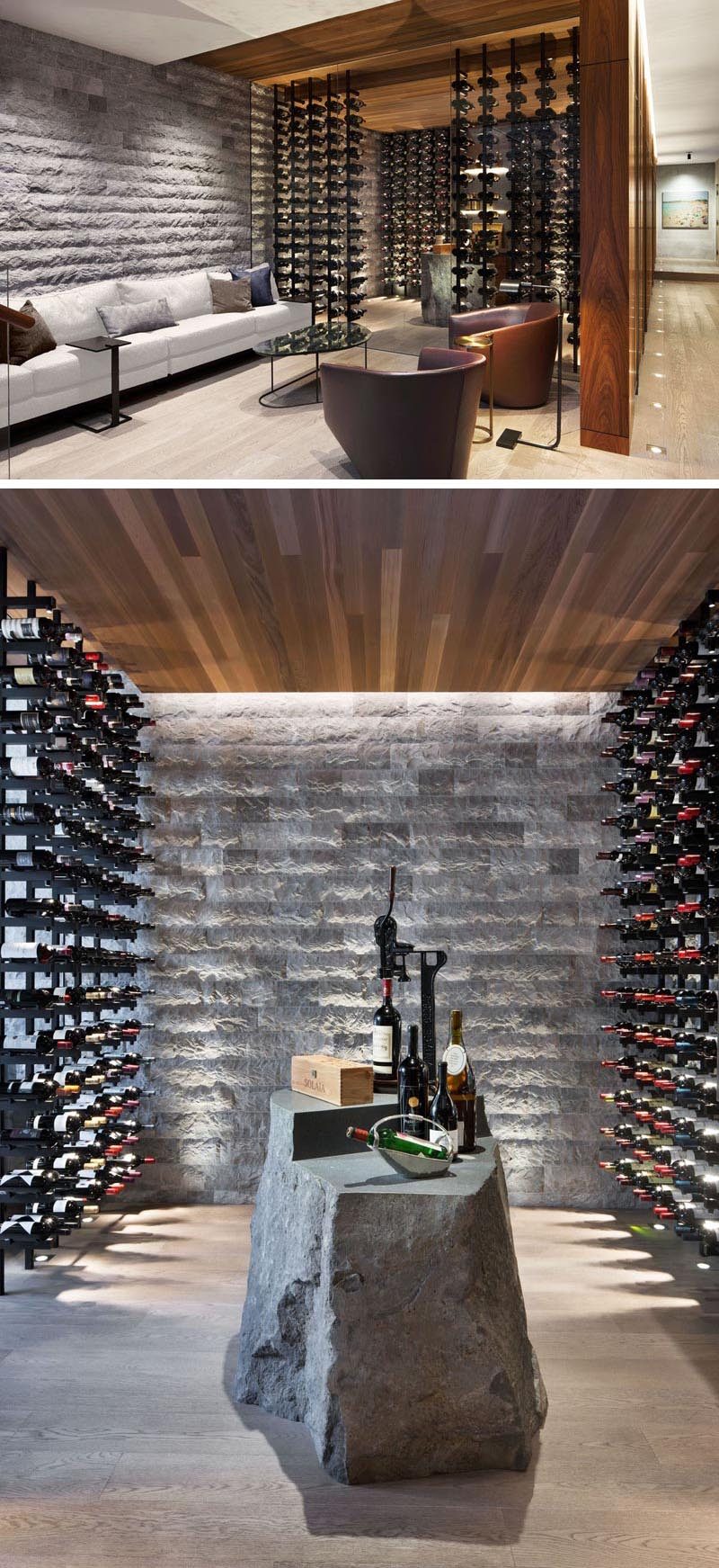 В этом современном винном погребе стеклянные стены, много места для хранения бутылок и каменный элемент, который можно использовать в качестве стола. #WineCellar #WineRoom #WineStorage
