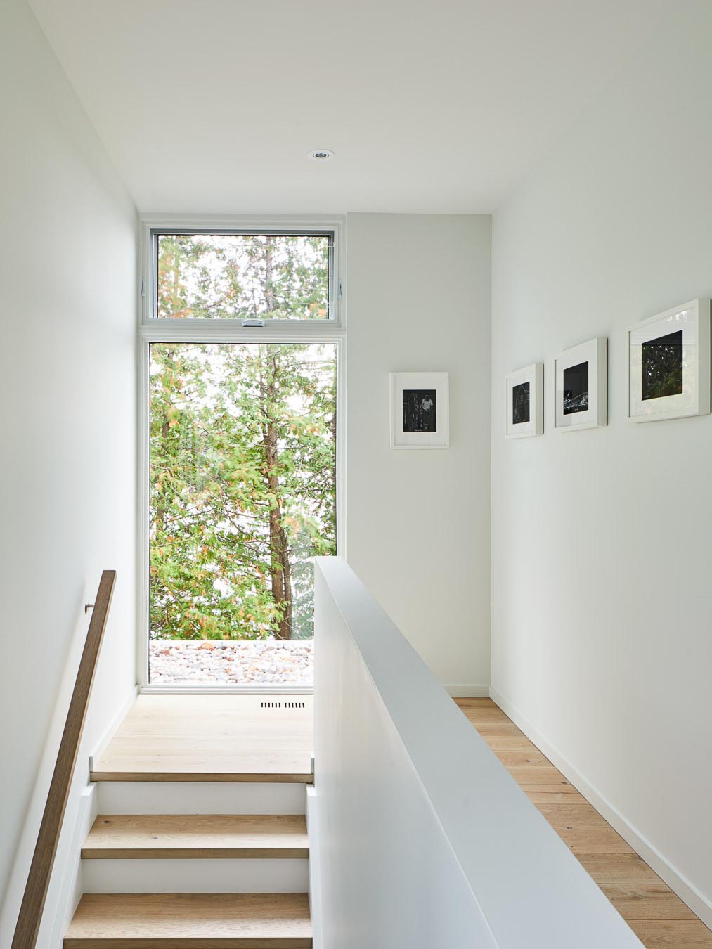 Белый интерьер с деревянными ступенями и полом.