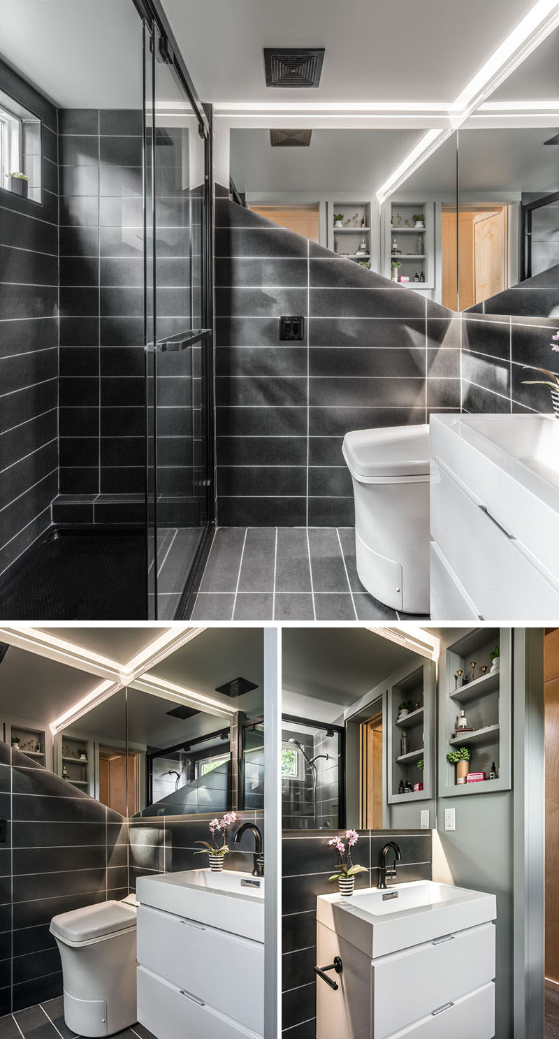 Эта небольшая и современная ванная комната в крошечном доме облицована индивидуальной плиткой и оснащена плавающим зеркалом со светодиодной подсветкой. Также есть нестандартная плавающая раковина, унитаз из печи для сжигания золы и полноразмерный душ 4х6 дюймов. # Ванная # Дизайн ванной